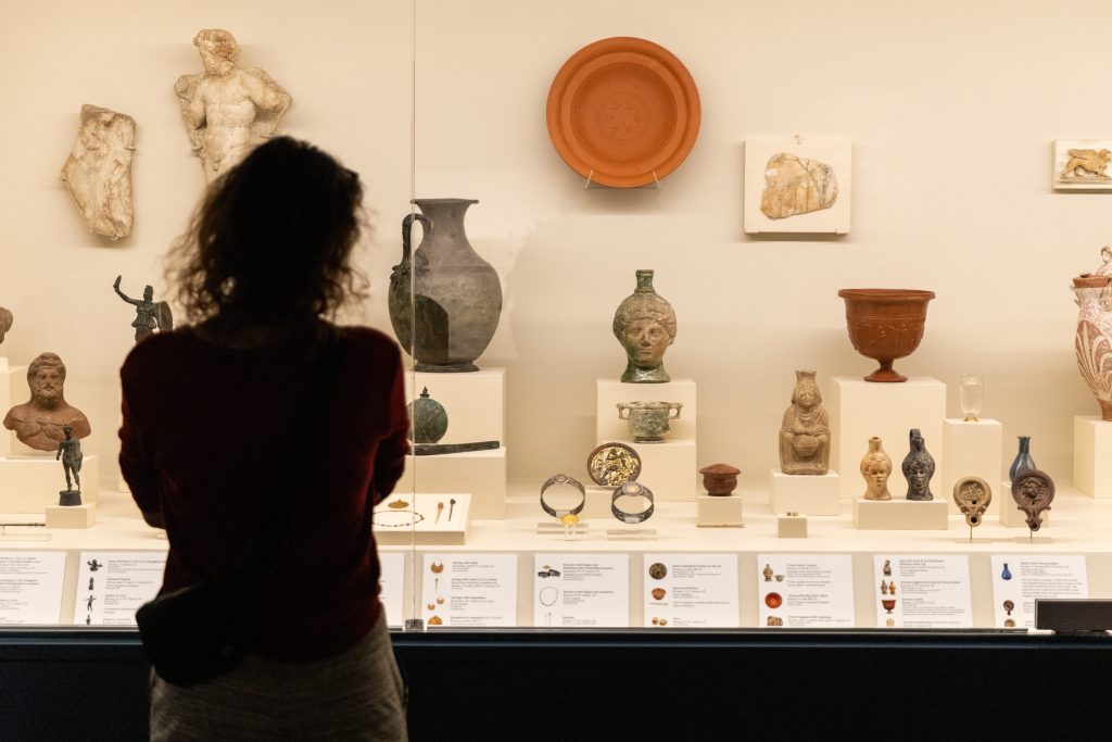 Woman views artifacts in a gallery
