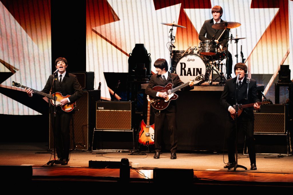 For performers dressed as the Beatles perform on stage