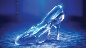 A gleaming glass slipper sits illuminated on a textured surface, radiating elegance. Blue tones and sparkling highlights create a magical, fairytale ambiance.
