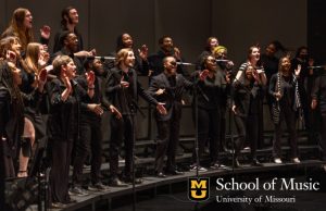 Choral Union singers on stage performing.