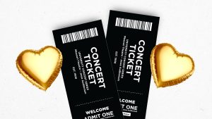 A pair of tickets and gold hearts.