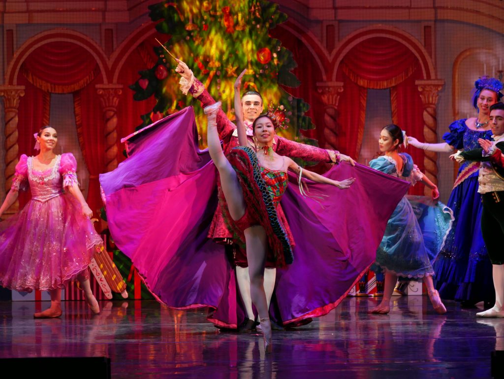 Performers on the stage of The Nutcracker! Magical Christmas Ballet dance at the holiday party.