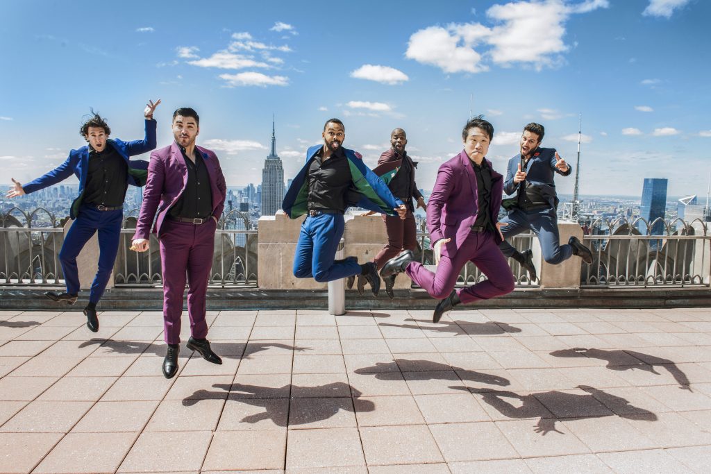 The Boradway Boys promotional image shows the group jumping charismatically on top of a roof with the New York City skyline in the distance.