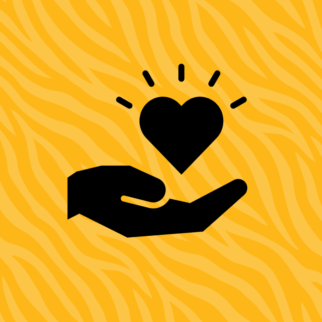 Hand holding a heart on a golden tiger stripe background.