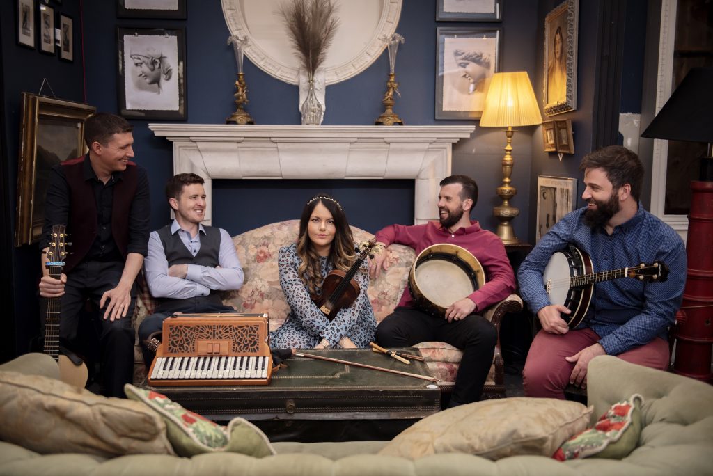 The five performers of Goitse sit together on a couch.