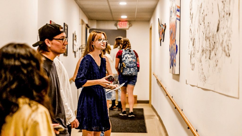 Students view art in the Fine Arts building